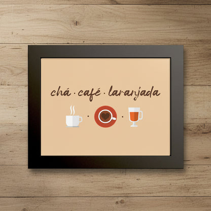 Framed wall art print with the words 'chá ¿café ¿laranjada' in brown script above simple illustrations of a white coffee cup, a red coffee saucer, and a glass of orange-red tea, all on a beige background inside a black frame.