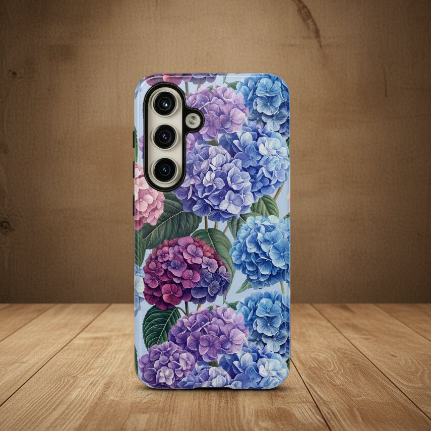 Phone case with a floral design featuring blue and pink hydrangeas on a white background