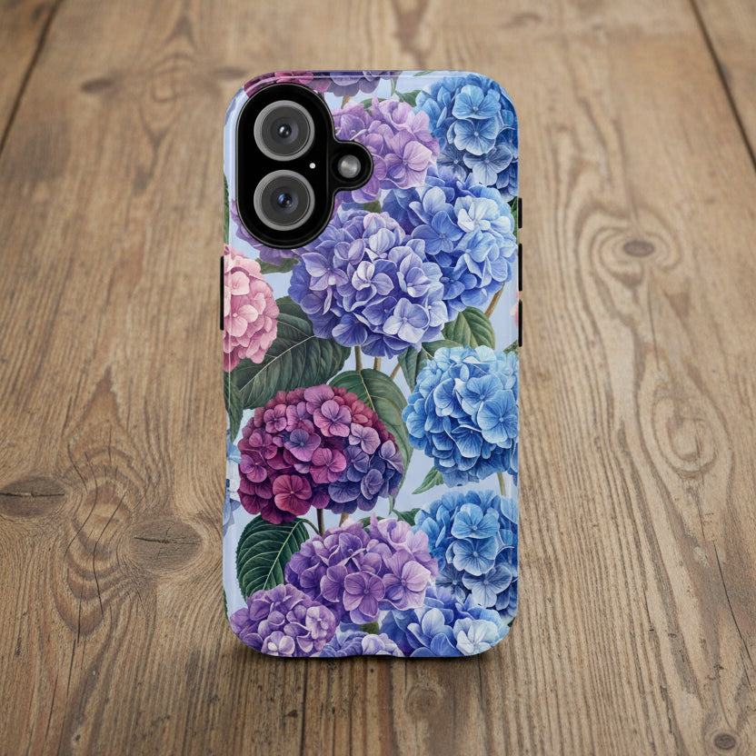 Phone case with a floral design featuring blue, purple, and pink hydrangeas on a white background.