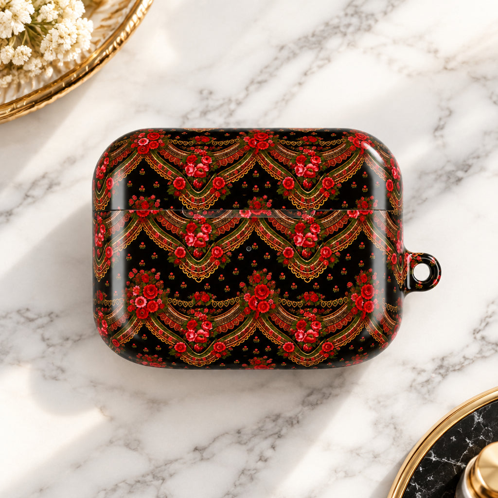 A glossy black AirPods case featuring an intricate red and gold traditional pattern, shown on a solid white background.