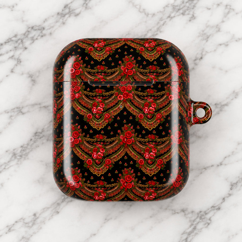 A protective case for wireless earbuds featuring an intricate red and gold traditional pattern on a black background, complete with a small hanging loop on the right side.