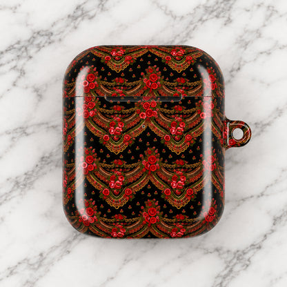 A protective case for wireless earbuds featuring an intricate red and gold traditional pattern on a black background, complete with a small hanging loop on the right side.