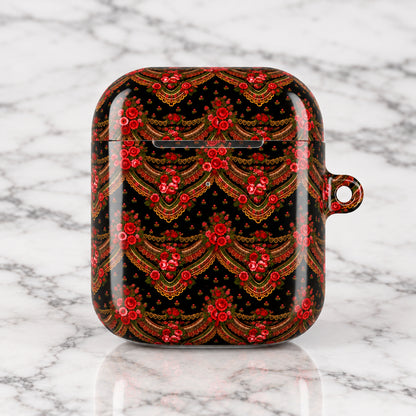 A protective case for wireless earbuds featuring an intricate red and gold traditional pattern on a black background, complete with a small hanging loop on the right side.