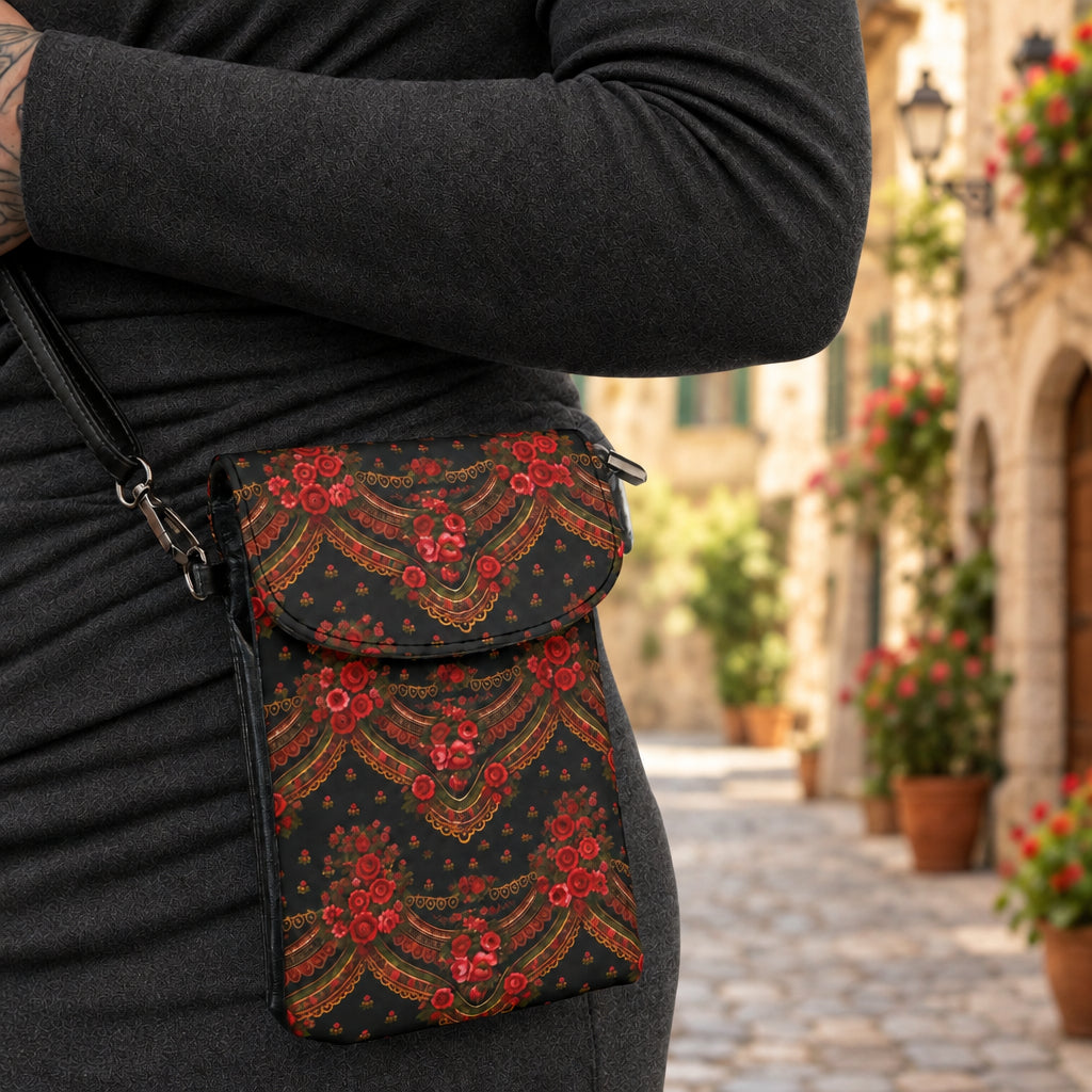 Black bag with colorful heart and unicorn pattern held by a person wearing a black leather jacket.