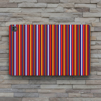 A protective tablet case featuring a vibrant, dense pattern of vertical stripes in red, orange, yellow, blue, purple, and white, shown on a stone wall