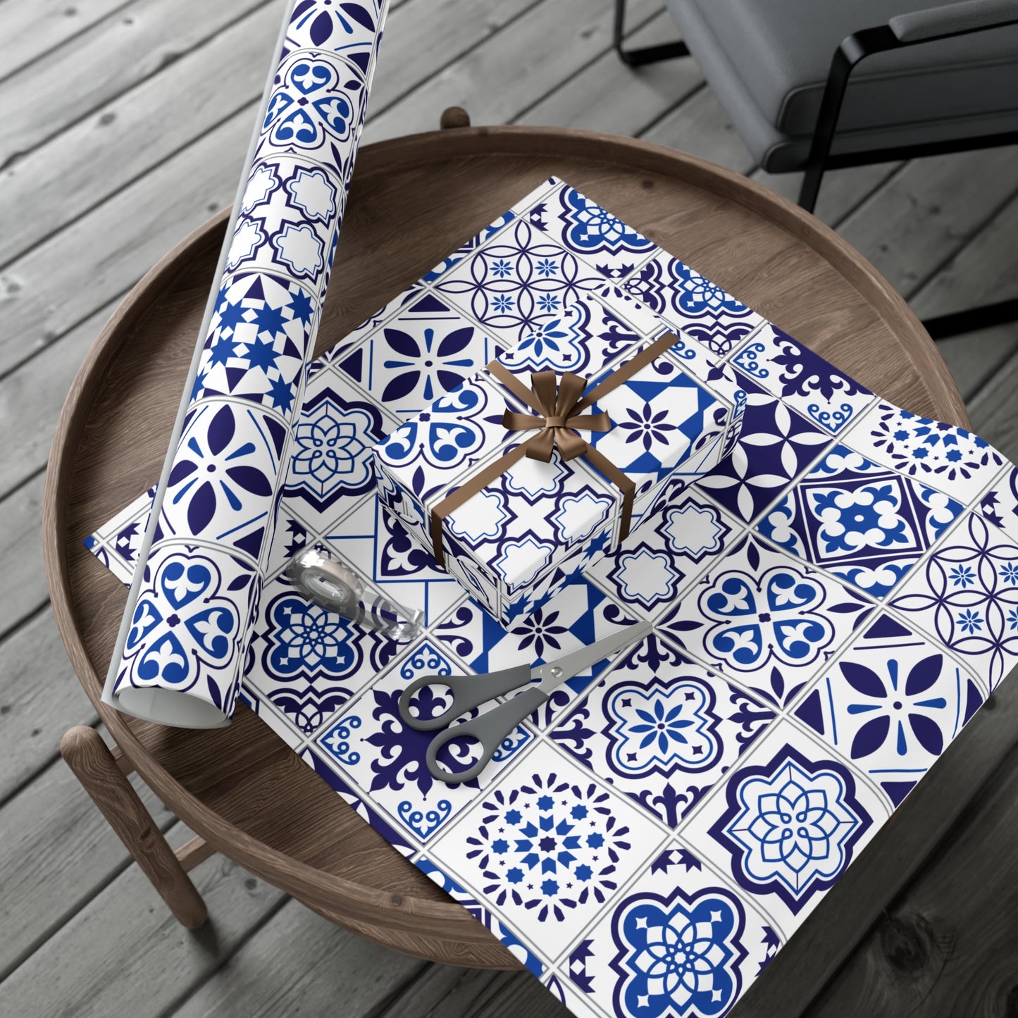 Rolls of blue and white patterned paper on a wooden table