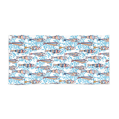 Patterned towel with colorful fish design on a white background